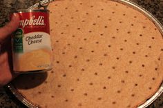 a can of campbell cheese being poured onto a pie pan with a polka dot design