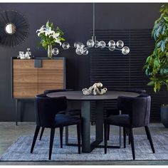 a dining room table with four chairs around it