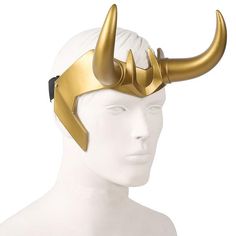 a white mannequin head with gold horns on it