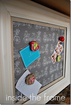 a framed photo with an apple, cookie and other items on the wall next to it