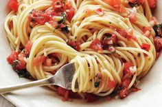 a white bowl filled with pasta and tomato sauce