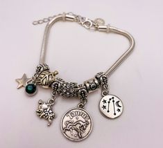 Taurus Charm Zodiac Bracelet expresses your characteristic traits of being a Taurus while wearing it. Express your independence, honesty, and compassion with this divine Zodiac Bracelet, which is made out of sterling silver snake chain with stainless steel silver coated Sagittarius sign, symbol, & constellation stars. After all, you deserve a Taurus Charm Zodiac Bracelet to encourage you to bring out your independent side, while expressing your unique & one-of-a-kind self! Embrace your inner sel Silver Zodiac Sign Bracelet, Silver Zodiac Sign Symbolic Bracelets, Silver Zodiac Sign Symbolic Bracelet, Sagittarius Sign Symbol, Characteristic Traits, Constellation Stars, Sagittarius Sign, Zodiac Bracelet, Silver Snake Chain