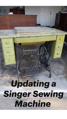 an old sewing machine sitting on top of a wooden table next to a garage door