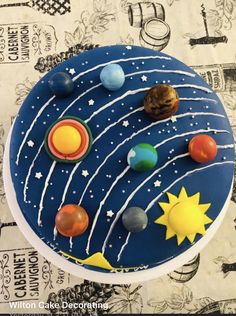 a cake decorated with planets and the sun