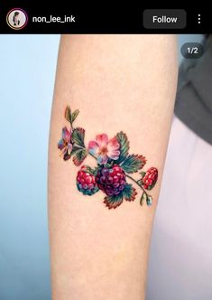 a woman's thigh with flowers and leaves on it