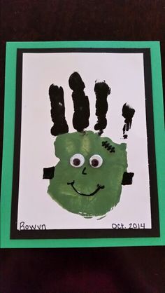 a green handprint with the words down town written on it and an image of a monster's face