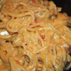 some noodles are being cooked in a skillet on the stove and ready to be eaten