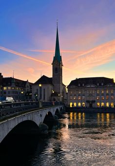 a bridge that has a clock tower in the background