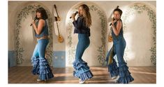 three women in blue outfits are singing into microphones