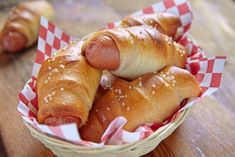 two hot dogs in buns wrapped in bread