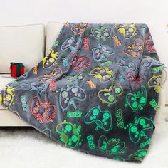 a couch with a blanket on it covered in colorful designs