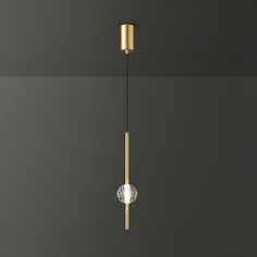 a modern light fixture hanging from the ceiling in a room with dark walls and flooring