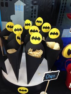 there are many cupcakes with batman decorations on them