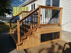 a wooden stair case next to a white house