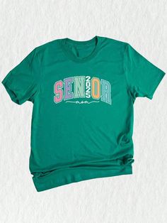 Get ready to celebrate the graduating class of 2025 with this trendy and stylish Senior 2025 T-shirt!  Designed specifically as a thoughtful graduation gift, this tee is perfect for seniors, college students, and anyone looking to commemorate this special milestone in style. Featuring a unique design that combines all the key elements of a truly memorable senior year, this shirt is a must-have for anyone in the class of 2025. ✨ The eye-catching graphic showcases the words "Senior 2025" in bold, Short Sleeve T-shirt With Text Print For Graduation, Crew Neck Tops For Graduation, Casual Crew Neck Top For Graduation, Graduation Graphic Print Short Sleeve T-shirt, Casual Graduation Shirt With Text Print, Graduation Text Print Crew Neck Top, Short Sleeve Shirt With Letter Print For Graduation, Short Sleeve Shirt With Text Print For Graduation, Casual Graphic Print T-shirt For Graduation