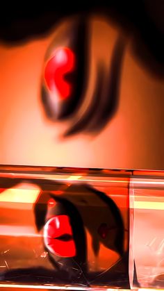 the reflection of a red object in a glass container