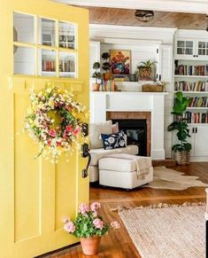 a living room filled with furniture and a fire place next to a fireplace covered in books