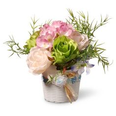 a vase filled with lots of flowers on top of a white table