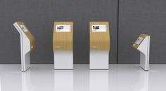 three gold and white atms in an empty room