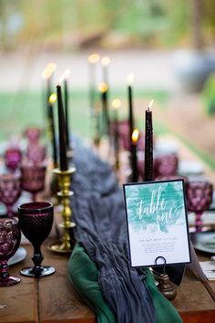 the table is set with candles and place cards