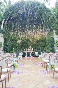 an outdoor ceremony set up with chairs and flowers