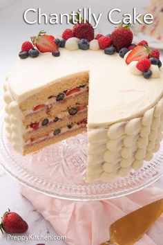 a cake with white frosting and berries on top