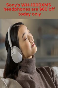 a woman wearing headphones while laying on a couch with her eyes closed to the side