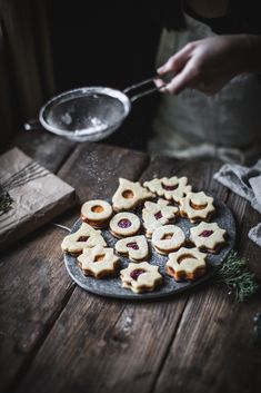 some cookies are on a plate and someone is holding a spoon