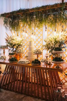 a table topped with lots of cakes and flowers