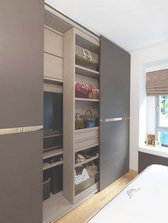 a bedroom with a bed, closet and television on the wall in front of it