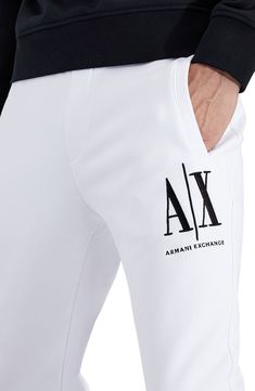 Dimensional Armani Exchange embroidery tops one leg of sweatpants knit from soft, breathable cotton in a fit that stays close for easy-moving comfort. Elastic waist with internal drawcord Front welt pockets; back welt pocket Banded cuffs 100% cotton Machine wash, tumble dry Imported Men's Clothing