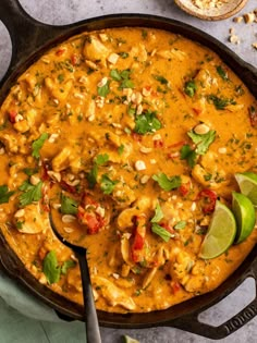 a skillet filled with mexican chicken and tortilla soup, garnished with cilantro