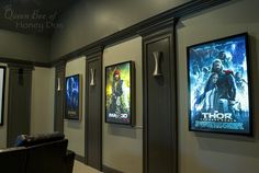 an empty movie theater with posters on the wall