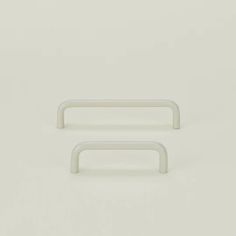 two white plastic handles on a white background