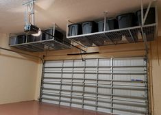 an overhead garage storage unit with hanging pots and pans