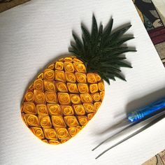 a pineapple is sitting on top of a piece of paper next to a pen