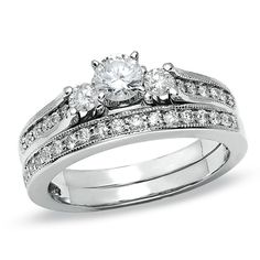 a white gold wedding ring set with two diamonds on the side and an engagement band