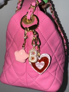 You're seen our viral bag charms content all over social media -- and ELLE Magazine, Who What Wear & the Wall Street Journal twice. We're excited to introduce this limited-edition DOUBLE HEART KEYCHAIN that is so darling that you will want to attach to all of your precious belongings. Featuring a cutesy double-heart charm and a bubbly pink star charm. Your choice to add a Blingy Bauble initial to level up! So perfect as a personalized gift. A few ideas on how to style this piece include but not Rectangular Logo Bag Charm, Gift Keychain With Logo Charm, Logo Charm Keychains For Gifts, Logo Charm Bag For Everyday Use, Trendy Pink Bag Charm For Gift, Pink Bag Charm Keychain For Everyday Use, Luxury Bag Charm With Keychain, Luxury Logo Bag Charm For Gift, Luxury Logo Bag Charm As Gift