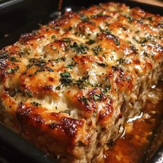 the meatloaf is covered with cheese and herbs