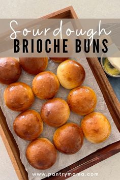 some doughnuts are sitting in a wooden tray with the words sourdough brioche buns