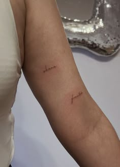 a woman's arm with a tattoo that reads, i love you in cursive writing