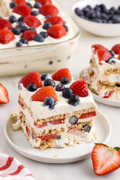 there is a piece of cake with berries on it and strawberries in the background