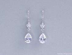 These are gorgeous sparkling wedding bridal earrings Made of Cubic Zirconia crystals, all components are rhodium plated over brass. Total length of the earrings: 48mm (approx. 2 inches) If you have any questions please send a message and I will be happy to answer you.  Come in a gift box at no extra cost, ready for gift giving!   The shipping costs INCLUDE international registered mail and insurance  Crystal bridal earrings CZ wedding earrings Cubic Zirconia teardrop earring Crystal tear drops earrings Marquise crystal bridal jewelry White Teardrop Wedding Earrings With Diamond Accents, White Diamond-accented Teardrop Earrings For Wedding, White Diamond Accent Teardrop Earrings For Wedding, White Diamond Accents Teardrop Earrings For Wedding, Pear-shaped Teardrop Earrings With Diamond Accents For Wedding, Pear-shaped Diamond Accented Bridal Earrings, Pear-shaped Bridal Earrings With Diamond Accents, Wedding Teardrop Cubic Zirconia Earrings, Diamond White Teardrop Crystal Earrings For Wedding