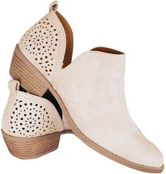 a pair of women's white shoes with cutouts on the side and wooden heel