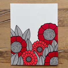 a card with red and gray flowers on it