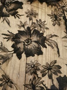 black and white flowers on sheer fabric with lace overlaying the image is very close up