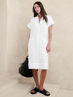 Effortlessly at-ease, we cut this shift dress from a beautiful blend of certified European linen and cotton—one we love for its lived-in look and ability to stay cool and crisp, even in heat and humidity.  Relaxed fit.  V-neck.  Pull-on design.  Side pockets.  Fully lined.  Relaxed fit.  Short sleeves.  Knee length.  Model: Size S, 5'10" (178cm). Utility Dress, Short Sleeve Midi Dress, Midi Short Sleeve Dress, Casual Stylish, Linen Shop, Cotton Style, Look Cool, Shift Dress, Jumpsuit Dress