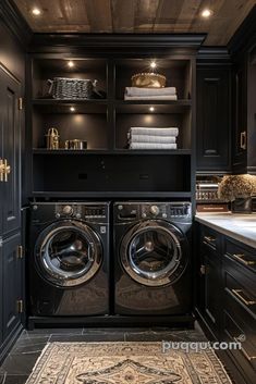 a washer and dryer in a room with dark wood floors, black cabinets and drawers