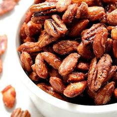 a white bowl filled with nuts on top of a table