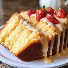 a piece of cake with icing and strawberries on top